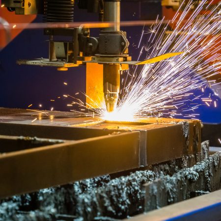 closeup shot of sparks flying from an industrial steel cutter